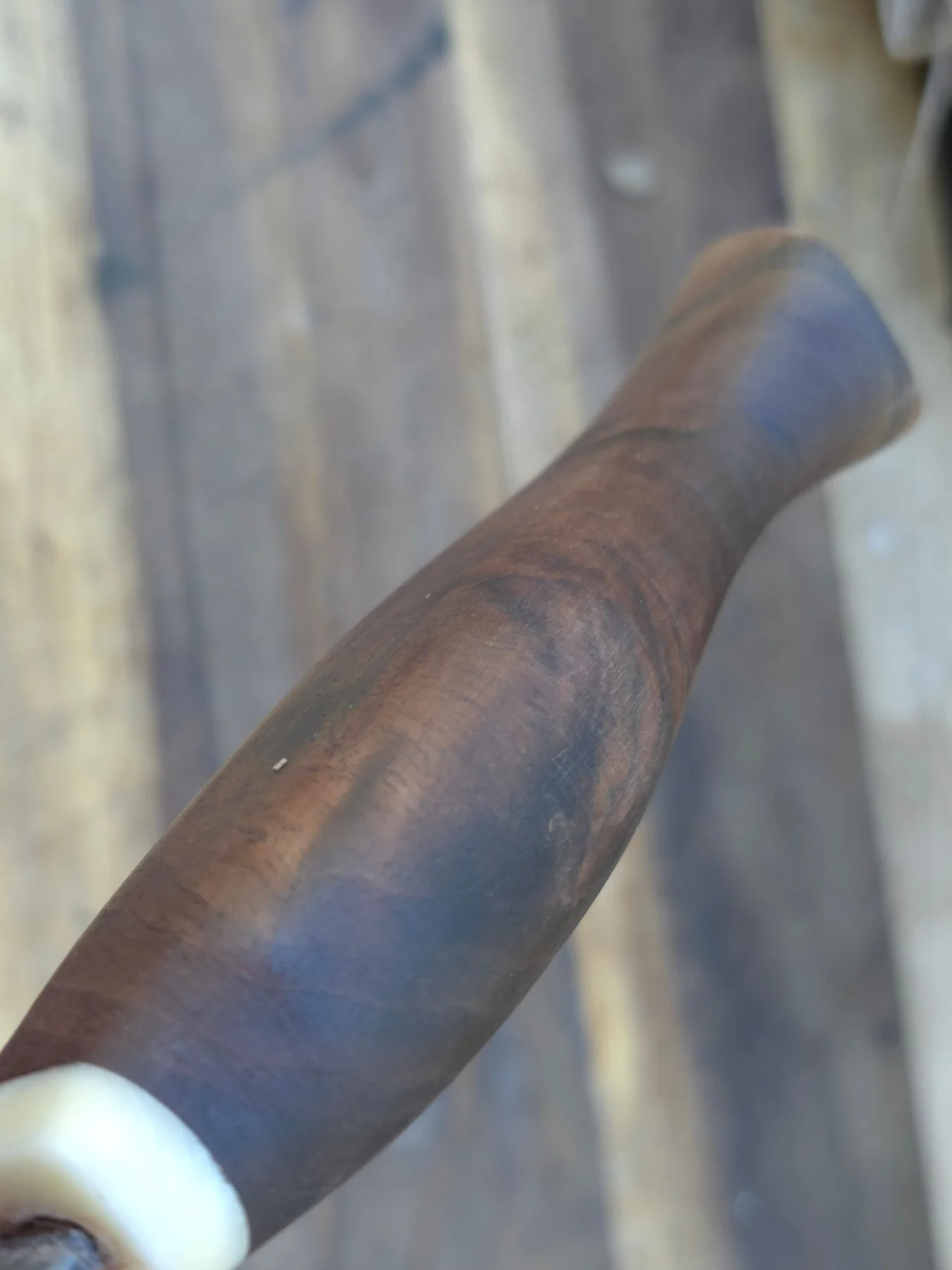 Sculpted dark wood knife handle with pale spacer