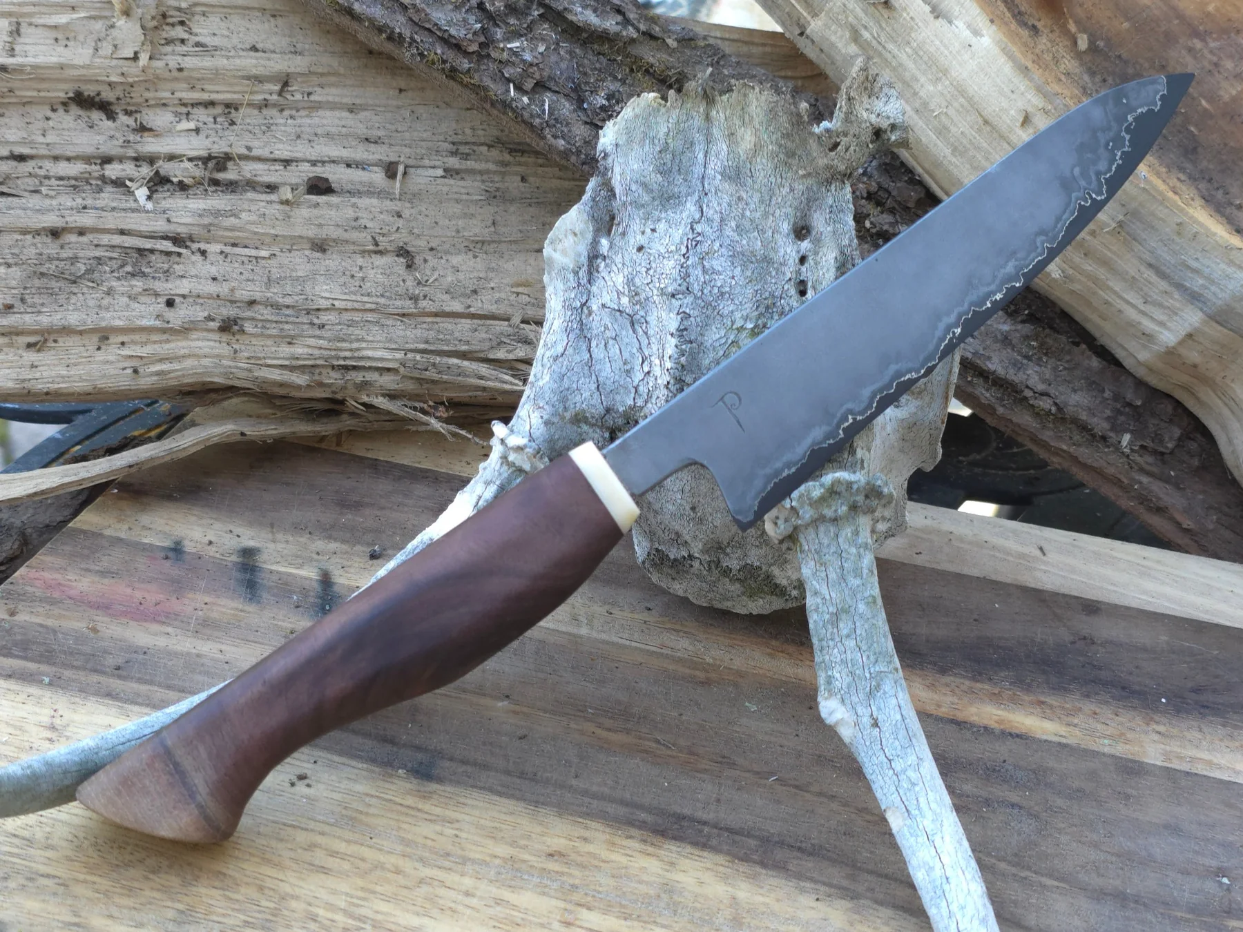 Finished hand-forged knife with sculpted wood handle and antler