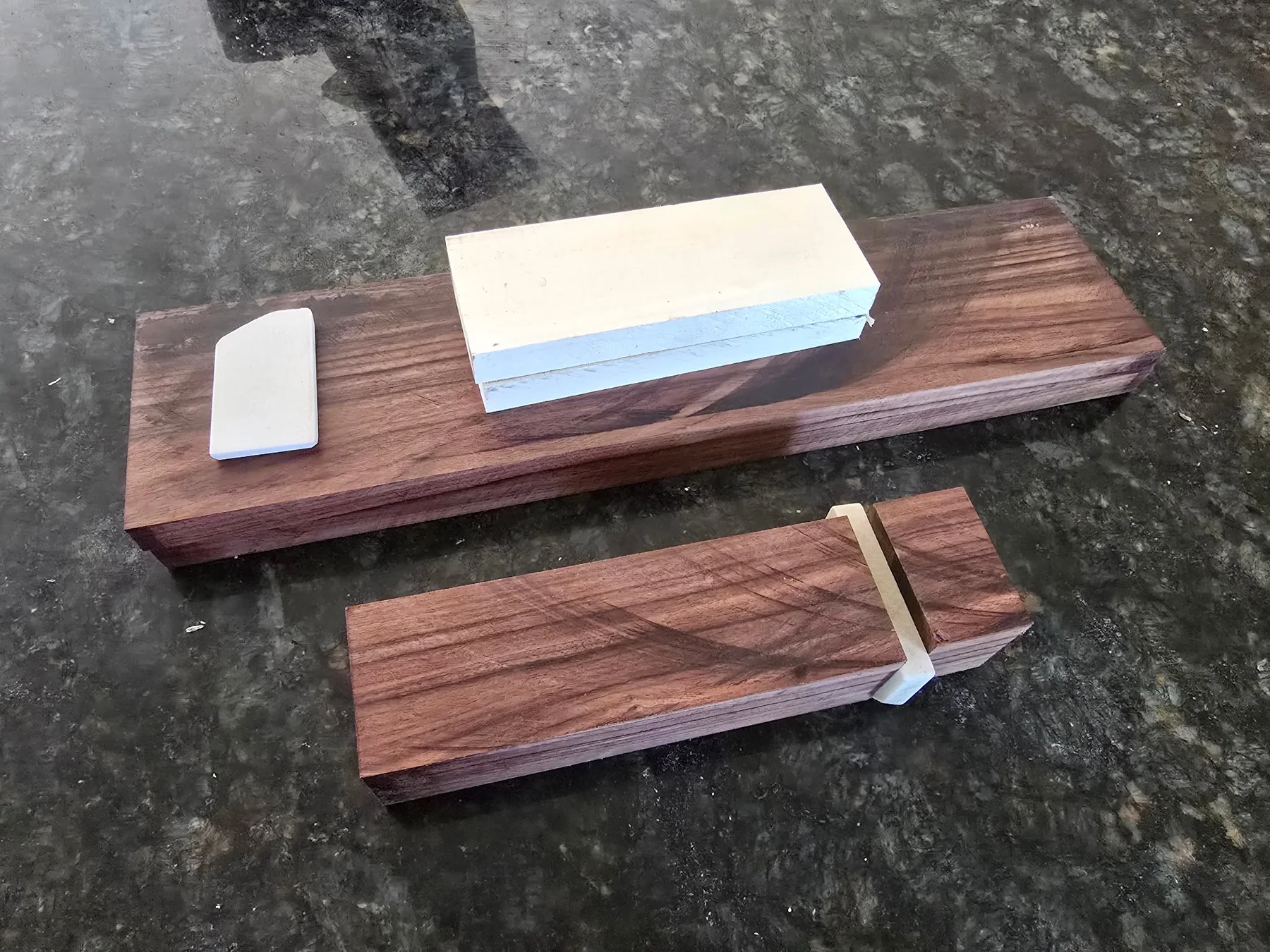 Wood and stone materials laid out for knife handles
