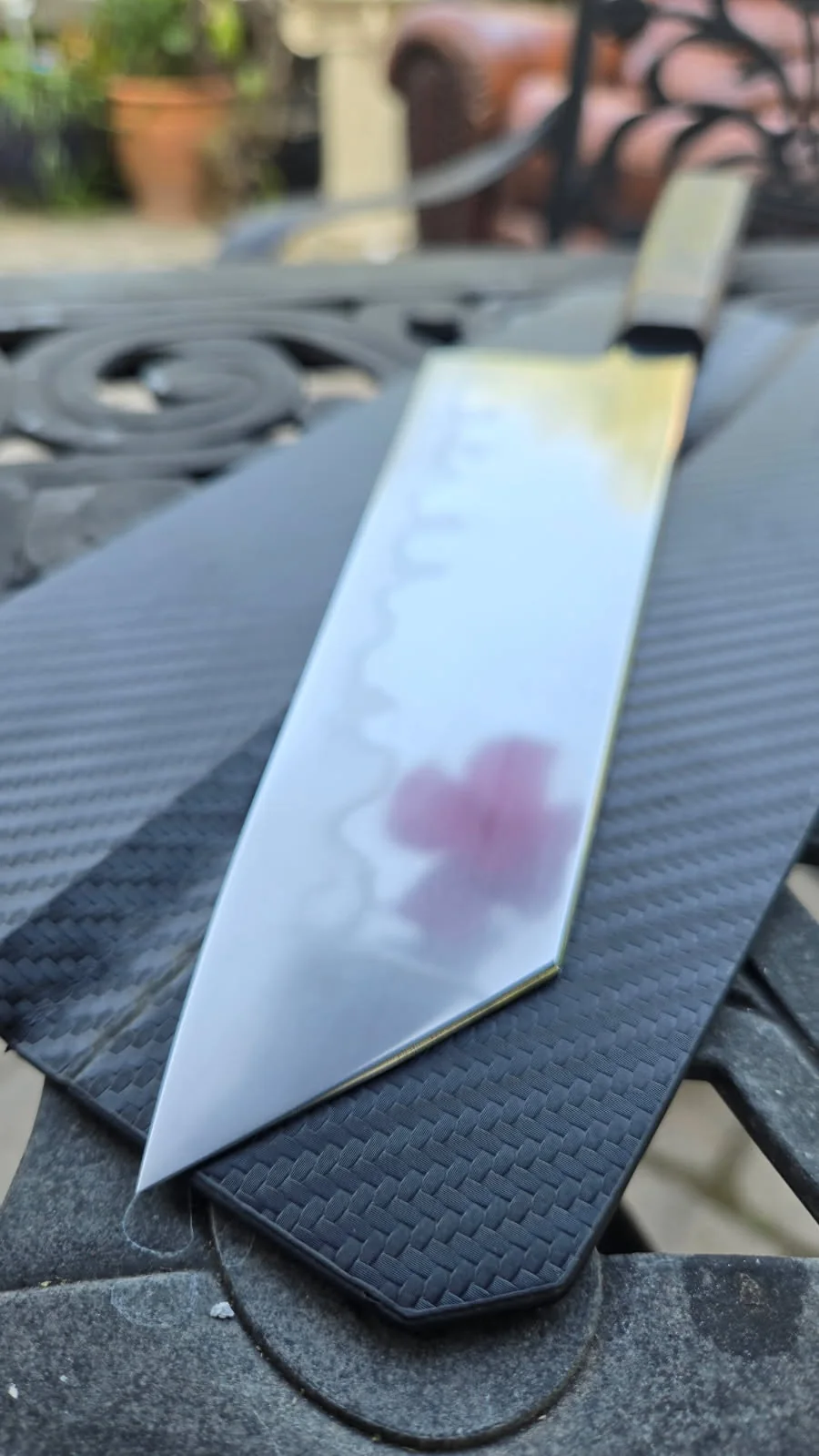 Polished blade reflecting color along a visible hamon