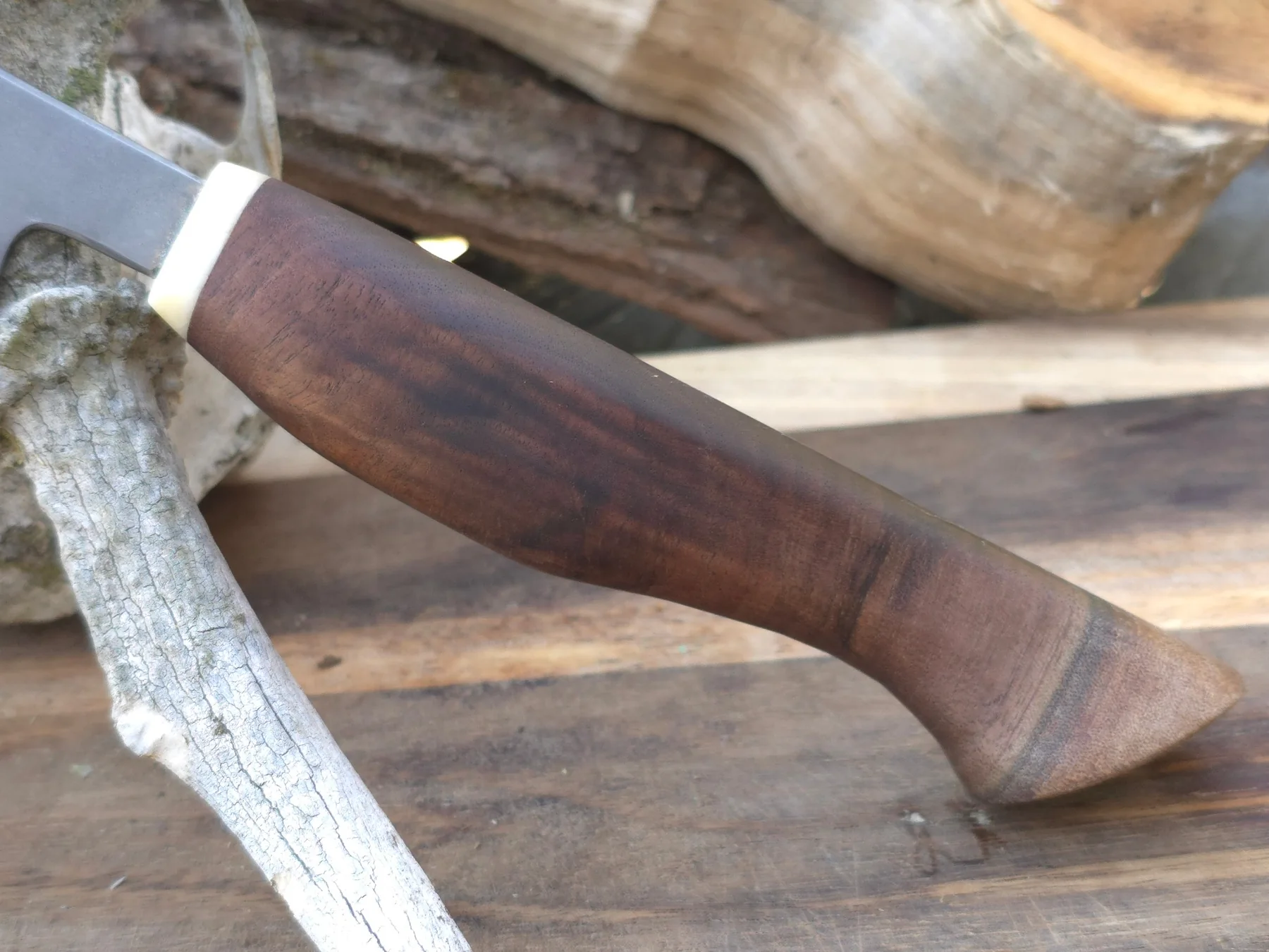 Sculpted figured wood handle with pale natural spacer